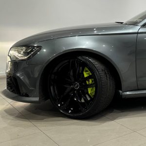 Diamond cut alloy wheel on a grey Audi car refurbished and colour changed to black with yellow calipers