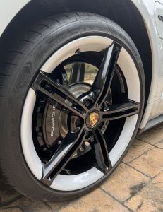 Alloy wheel with black spokes and white outer rim