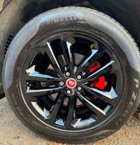 Black high gloss finish Jaguar alloy wheel with red painted caliper