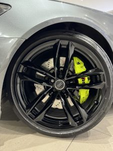 Black Audi wheel with acid green caliper